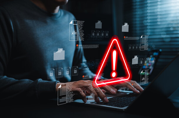 Data security warning and cyber risk alert concept. Person using laptop with digital files, lock icon, red warning symbol. data breach, document protection, threat detection, secure incident response